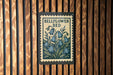 A sign with the text "BELLFLOWER BED" and an illustration of blue flowers is hanging on a wooden wall.
