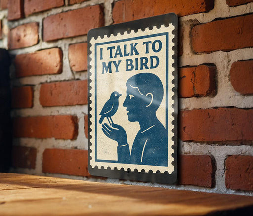 a sign with a blue background and a white border, depicting a man holding a bird. The sign is mounted on a brick wall.
