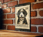 A metal sign featuring a Bernoodle dog on a brick wall.