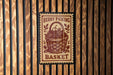 A berry picking basket sign is displayed on a wooden wall.