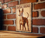 a wooden sign with a picture of an IBIAN HOUND dog, mounted on a brick wall.