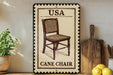 A framed illustration of a cane chair is displayed on a shelf, accompanied by a wooden cutting board and a potted plant.