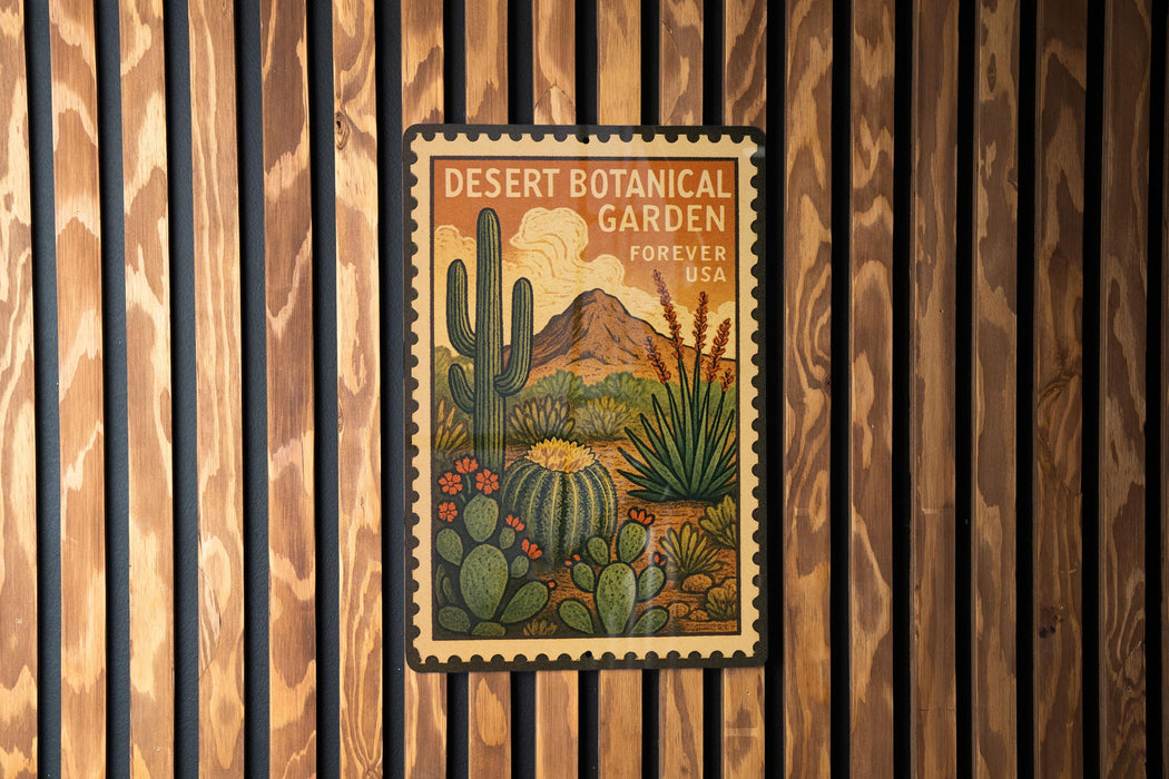 A vintage-style poster of a desert garden with cacti and other desert plants, displayed on a wooden wall.