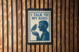 a sign with the text "I TALK TO MY BIRD" and an illustration of a person holding a bird.