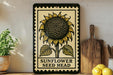 A framed illustration of a sunflower is displayed on a shelf, accompanied by a wooden cutting board, a potted plant, and some lemons.