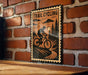 A metal sign with a bicycle illustration and the text "TRAIL CYCLING" is displayed on a brick wall.