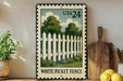 A vintage-style metal sign with a white picket fence illustration, mounted on a wall next to a wooden cutting board and a potted plant.