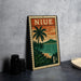A vintage postage stamp featuring a tropical landscape with palm trees and a sunset over the ocean, placed on a table next to some black camera lenses.