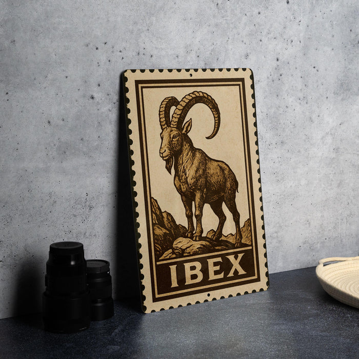 a metal sign with a printed illustration of a ram, and the word "IBEX" is written below the illustration.
