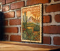 A metal sign with a desert botanical garden design is mounted on a brick wall.
