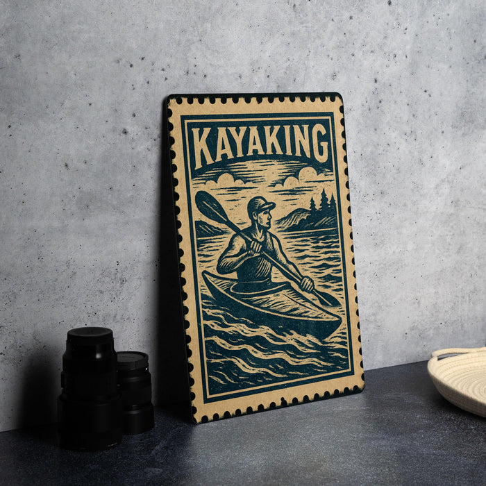 A framed illustration of a person kayaking, with the word "KAYAKING" prominently displayed.