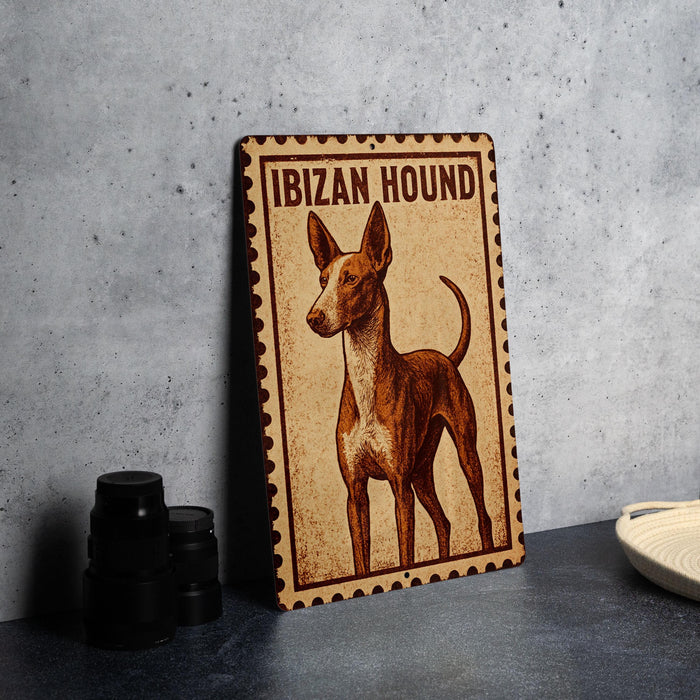 A metal sign with the text "IBIZAN HOUND" and an illustration of a hound dog.