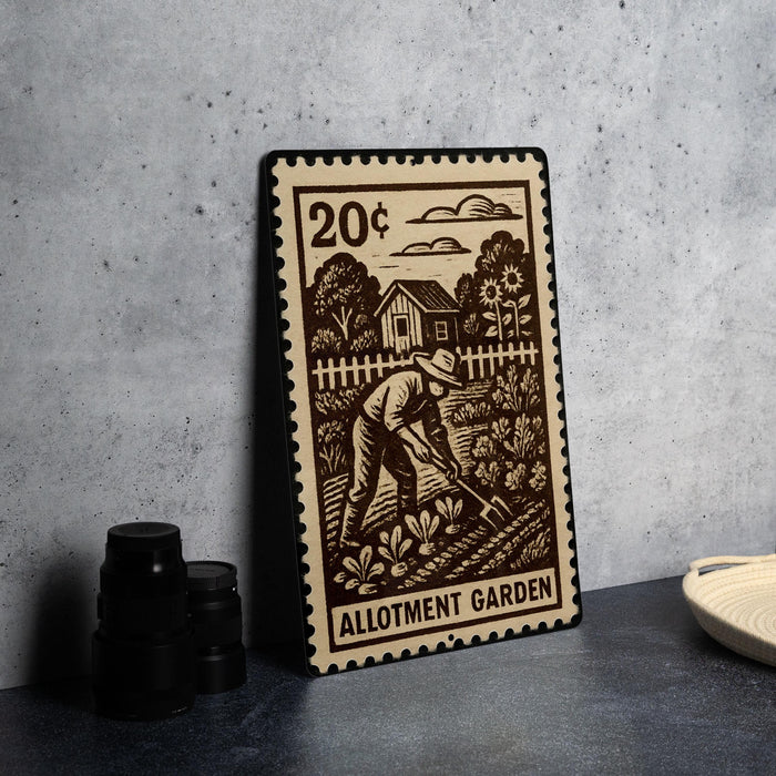 A metal stamp depicting a man working in a garden, with the text "ALLOTMENT GARDEN" printed on it.