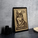A metal stamp featuring a close-up of a dog's face, with the text "TAMASKAN DOG" printed on it.