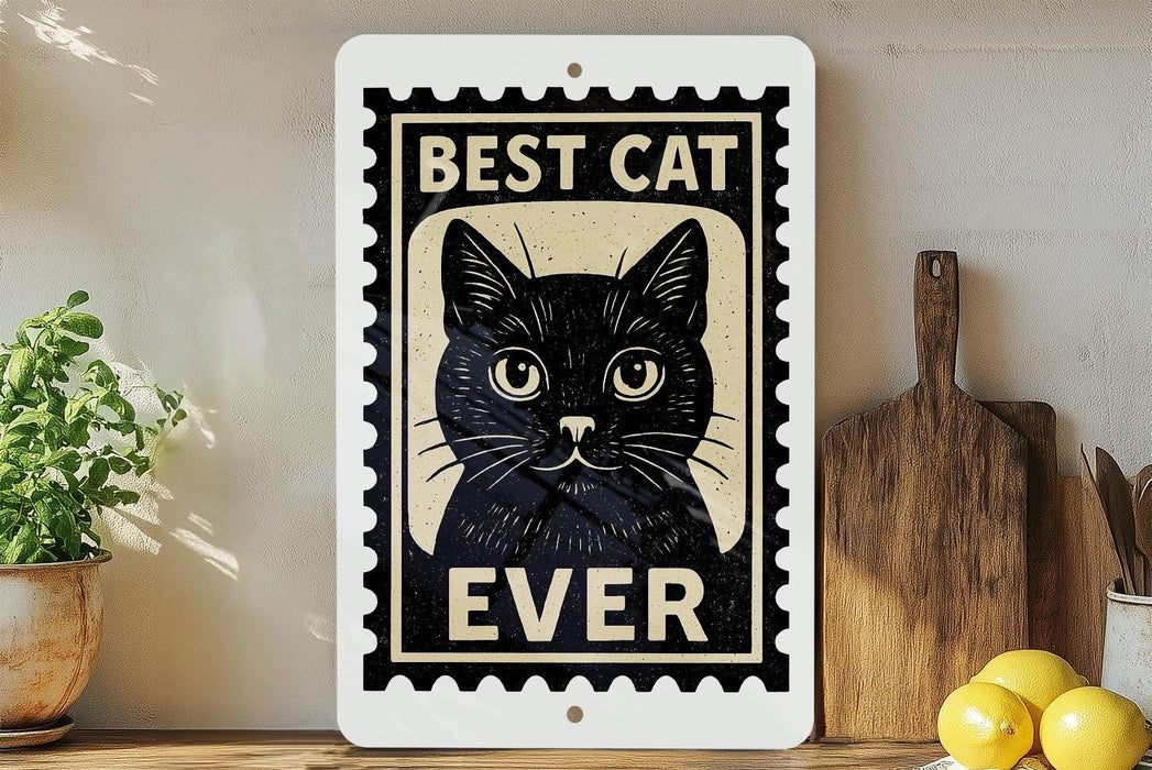 A framed sign with a black cat illustration and the text "BEST CAT EVER" is displayed on a shelf next to a wooden cutting board and a potted plant.
