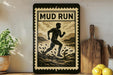 a framed poster with a silhouette of a person running, accompanied by the text "MUD RUN" in bold letters. The poster is displayed on a shelf, with a potted plant, a wooden cutting board, and some lemons nearby.