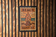 A poster with the text "BEACH BONFIRE" and an illustration of a campfire on a beach.