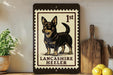 A framed image of a Lancashire Heeler dog, a breed of small, medium-sized, and energetic working dogs, is displayed on a shelf.