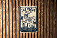 A vintage-style welcome sign for Las Vegas, Nevada, featuring the iconic Las Vegas skyline and text welcoming visitors to the city.
