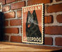 A poster of a Belgian sheepdog is displayed on a brick wall, with the text "Belgian Sheepdog" prominently featured.