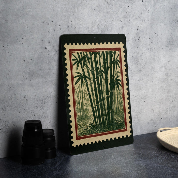 a framed print of bamboo plants on a wall, with a black border and a red border. There are also some black camera lenses and a white dish on a countertop.