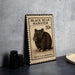 A black bear hamster postage stamp is displayed on a table, with a stack of black camera lenses and a woven basket nearby.