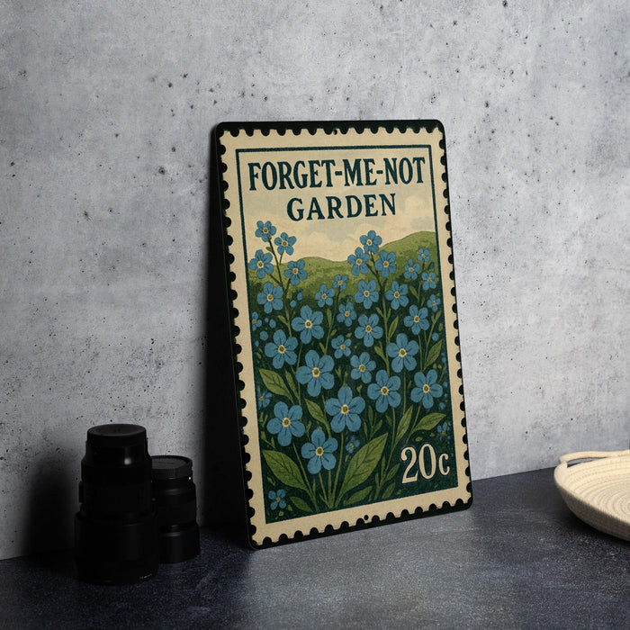 a metal sign with a floral design, placed on a table next to some black camera lenses.