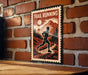 A metal sign with a silhouette of a person running in front of a mountain landscape, mounted on a brick wall.