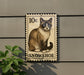 A 10c postage stamp featuring a Siamese cat, with the word "SNOWSHOE" written below it.