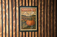 A pumpkin patch sign is hanging on a wooden wall.