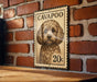 A vintage-style metal sign featuring a dog's portrait on a brick wall.