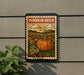 A pumpkin patch sign is displayed on a wall, featuring a large orange pumpkin surrounded by green leaves and a cloudy sky.