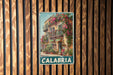A vintage metal sign with a colorful illustration of a building with flowers on the balcony, mounted on a wooden wall.