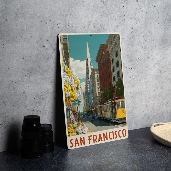 A vintage-style metal sign featuring a colorful illustration of a street scene in San Francisco, with a trolley car and buildings in the background.