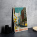 A vintage-style metal sign featuring a colorful illustration of a street scene in San Francisco, with a trolley car and buildings in the background.