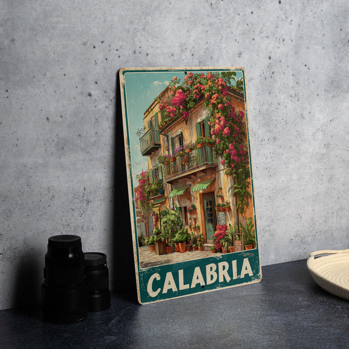 A vintage metal sign displaying a colorful illustration of a building with flowers on the balcony, set against a gray background.