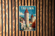 A vintage-style poster of Tallinn, the capital city of Estonia, is displayed on a wooden wall.