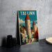 A framed poster of a castle with the word "TALLINN" written on it, displayed on a wall next to some black camera lenses.