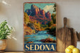 A vintage-style metal sign displaying a scenic image of Sedona, Arizona, with a river and mountains in the background.