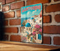A vintage-style poster of Santorini, Greece, featuring colorful buildings, blue domes, and pink flowers against a bright blue sky.