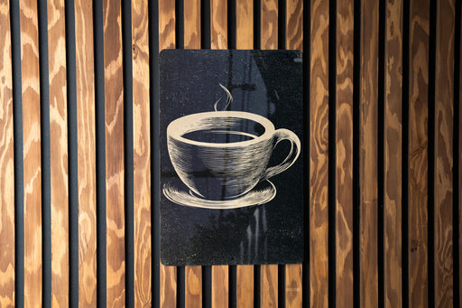 A black and white illustration of a cup of coffee is displayed on a wooden wall.