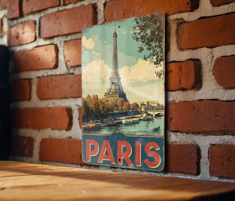 A vintage-style metal sign featuring the Eiffel Tower and a river, mounted on a brick wall.