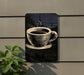 A black and white illustration of a coffee cup is displayed on a wall, with a plant visible to the left.