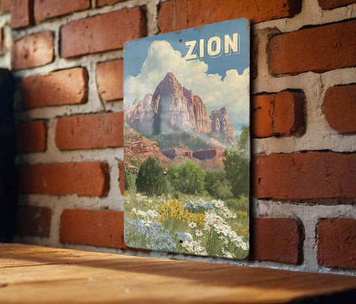 A vintage-style metal sign with a landscape of mountains and a field of flowers, mounted on a brick wall.