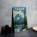 A framed vintage-style poster of Yukon, the western territory of Canada, featuring a mountain landscape with a lake and pine trees.