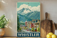 A vintage-style poster of Whistler, British Columbia, Canada, featuring a mountain landscape with colorful buildings and a bustling street scene.