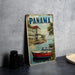 A vintage-style metal sign with the word "PANAMA" prominently displayed, featuring a scenic image of boats on a river and buildings along the shore.