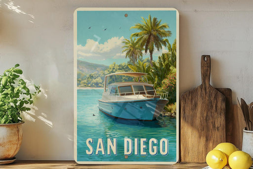 A vintage-style metal sign with a painting of a boat on a body of water, surrounded by palm trees, with the text "SAN DIEGO" prominently displayed.