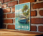 A vintage-style sign featuring a boat on a tropical beach, with palm trees and a blue sky in the background, mounted on a brick wall.
