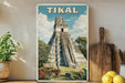A vintage-style poster of the Mayan pyramid of Tikal, a famous landmark in Guatemala, displayed on a wall.